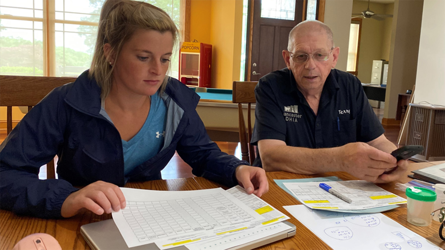 two people looking at printer DHI reports